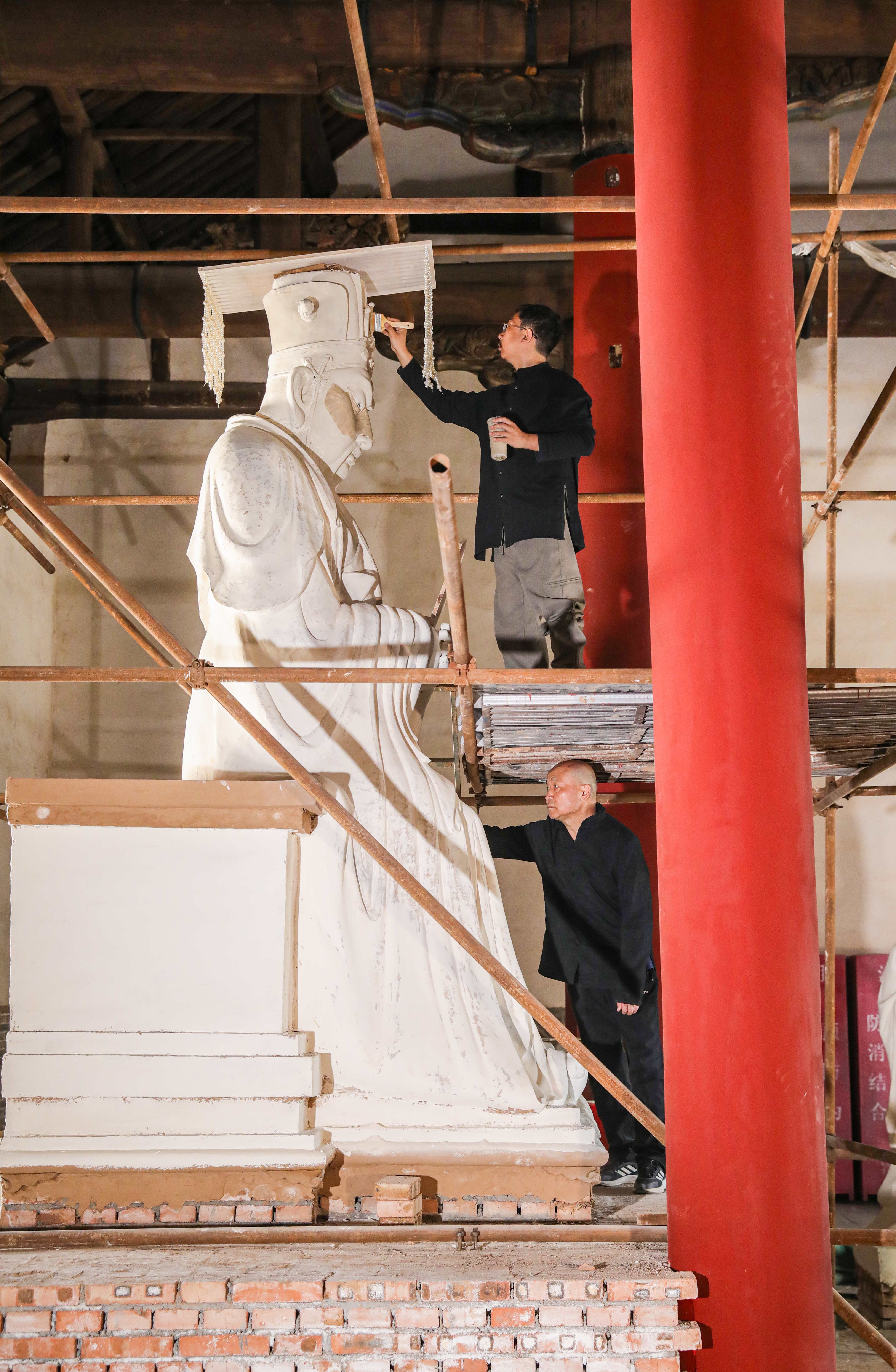    劉子群父子在臨汾鼓樓關帝廟合力完成彩塑。王帆 攝
